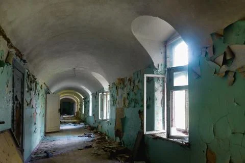 Corridor with broken windows in an old abandoned building Фото