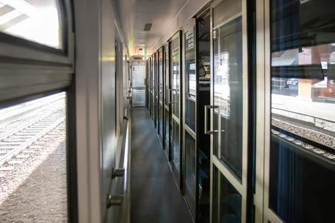 A corridor inside a passenger Second-class train carriage in Poland. Long and Stock Photos