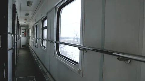 Corridor of the intercity passenger train. You can see the winter landscape in Stock Footage 292120854