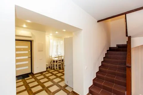 Corridor, kitchen and stairs to the second floor in the cottage Stock Photos