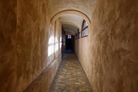Corridor of a monastery with light projected onto the walls from the windows Stock-Fotos