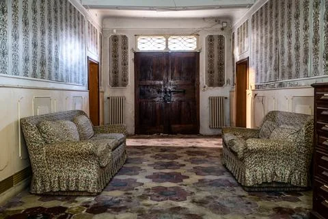 Corridor with sofas of an abandoned house, Urbex In northern Italy Stock Photos