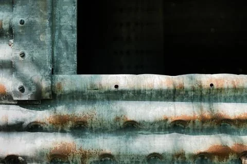Corroded,. galvanized side of old silo with darkened opening Stock Photos