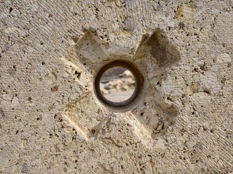 Corroded iron embedded in stone surface, Closeup of metal ring set into sto.. Фото