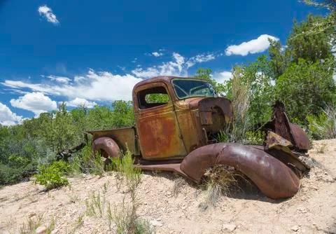 Corroded Oldtimer grown into the surrounding Landscape Stock Photos