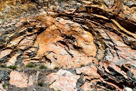 Corroded rock relief structure rough background texture. Stock Photos