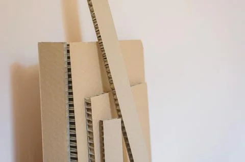 Corrugated board of different sizes stands against the wall Stock Photos