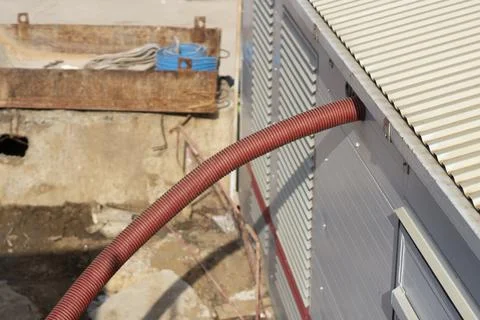A corrugated cable. The cable enters the structure. Foto stock