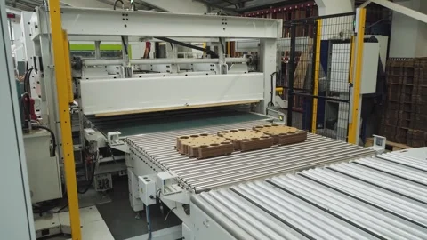 Corrugated cardboard packaging production machine. Automated conveyor line for Stock Footage 280120245