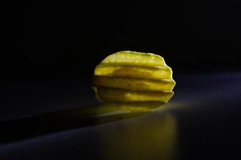 Corrugated chips in on a black background Stock Photos