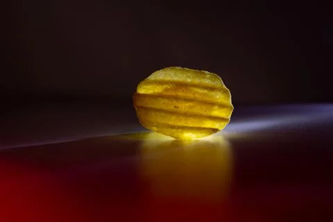 Corrugated chips in red light on a background Stock Photos