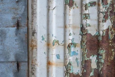 Corrugated iron surface is covered with old paint, chipped paint, texture b.. Stock Photos