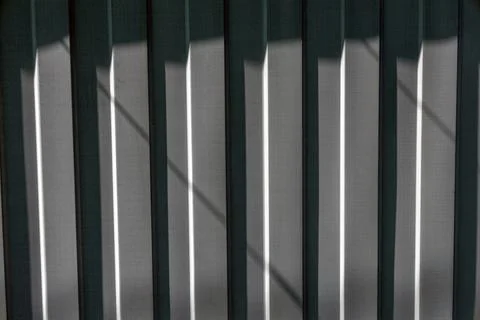 Corrugated metal surface texture with sunlight shadow pattern detail Stock Photos