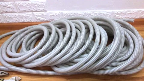 Corrugated pipes for electrical wire lie on the floor in the house during Stock Footage 215740553