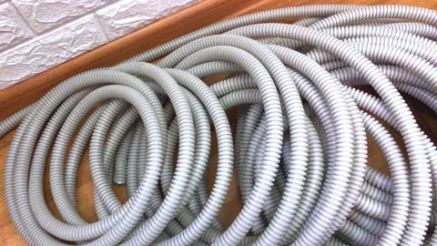 Corrugated pipes for electrical wire lie on the floor in the house during Stock Footage 215741202