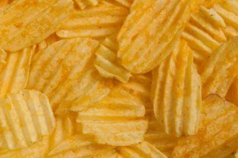 Corrugated potato chips in the background Stock Photos