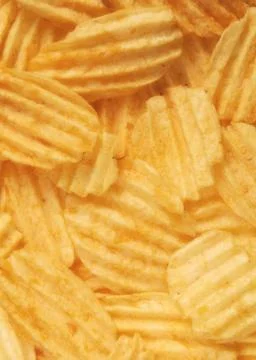Corrugated potato chips in the background Stock Photos