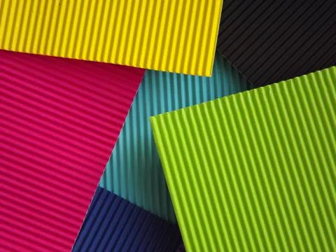 The corrugated surface is multicolored with parallel lines as a background bl 库存照片