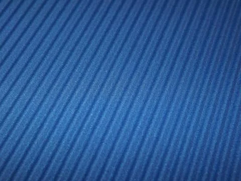 The corrugated surface is multicolored with parallel lines as a background black Foto stock