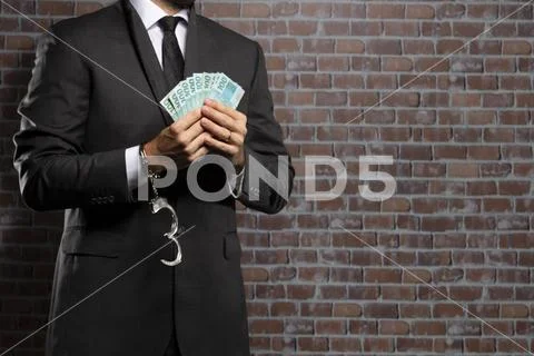 Corrupt man holding bills of money Stock Photos