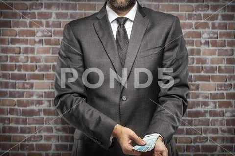 Corrupt man holding bills of money Stock Photos