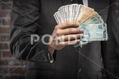 Corrupt man holding bills of money Stock Photos