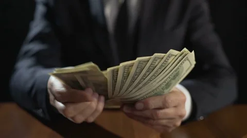 Corrupt official counting bundle of money, taking bribe for abuse of power Stock Footage