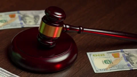 Corruption and bribery concept. Close-up Judge gavel and dollar money on a .. 動画素材 292973997