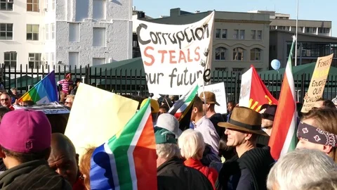 Corruption steals our future sign at Jacob Zuma march to parliament Video stock 78550538