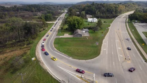 Corvette car parade approaching intersection to highway. Stock Footage 166136479