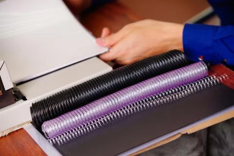 Cose up of plastic ring of different sizes and colors used for binding documents Stock Photos