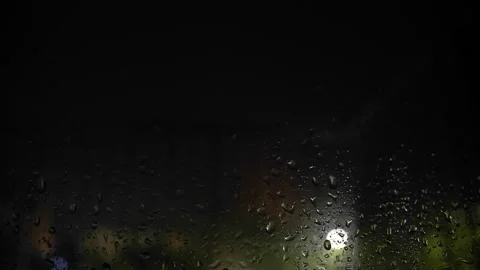 Cose-up of rainfall. Drops on glass. Rain. Bolts of lightning. City at night Stock Footage 246918140
