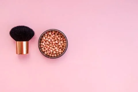 Cosmetic blush in spheres on a pink background. Place for text. Top view. Fla Stock Photos