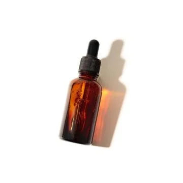 A cosmetic bottle with reflected effect isolated on the white background. Stock Photos