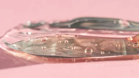 Cosmetic brush close-up with transparent serum macro, gel smears Video stock 234875223
