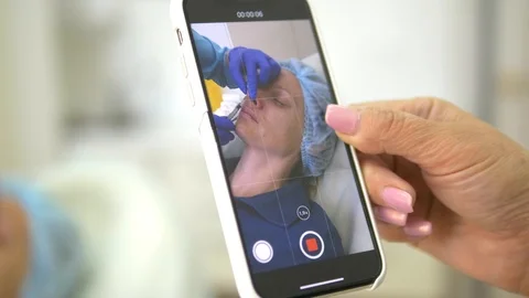 Cosmetic concept. Correction of the contour of the nose. Assistant makes video Stock Footage 112069965