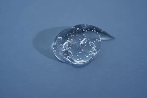 Cosmetic gel on a blue background. Texture. Stock Photos