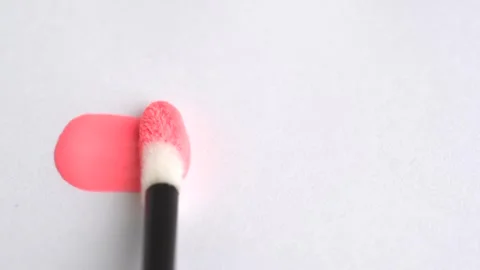 Cosmetic liquid lip gloss, lipstick smudge of peach fuzz color, smear, stro.. Stock Footage 266817853