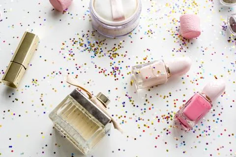 Cosmetic objects and confetti isolated on background Stock Photos