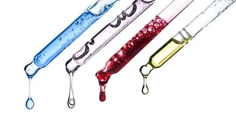 Cosmetic pipette droppers with different colored skincare serum Stock Photos