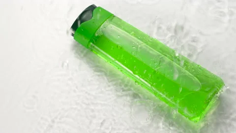 Cosmetic plastic bottle in splashes and drops of water. Skin care product, green Stock Footage 164240865