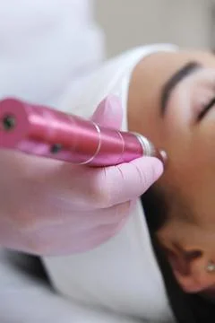 Cosmetic Professional Using a Dermaroller Device Stock Photos