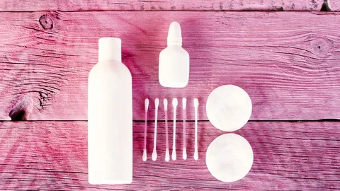 Cosmetic set is white. Jars, cotton pads and cotton sticks on a pink background. Stock Footage 127591025