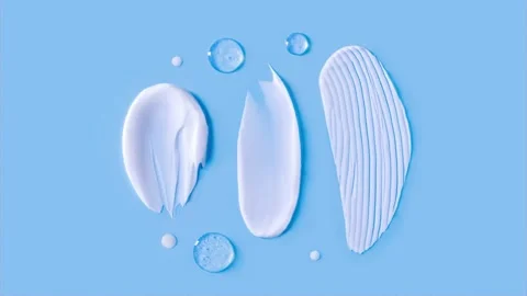 Cosmetic smears cream texture on blue background Stock Footage 234992853