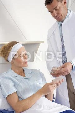 Cosmetic surgeon and female patient Stock Photos
