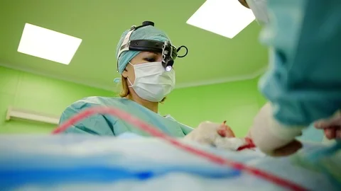 Cosmetic surgeon is correcting shape of human nose during operation in ENT Видео 97001768