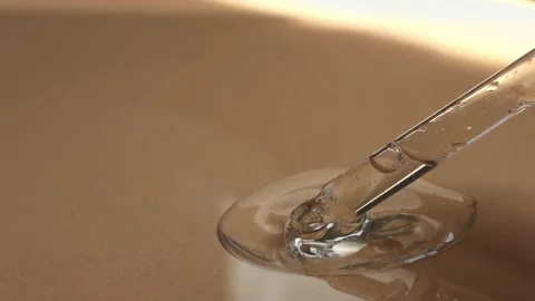 Cosmetic texture with bubbles flowing down from a glass dropper close-up. Stock Footage 218314144