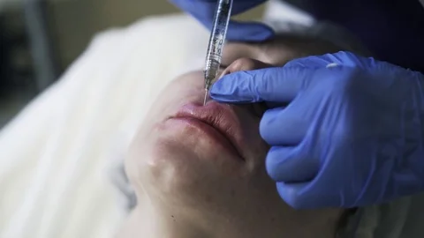 Cosmetican doing upper lip shot 動画素材 75692854