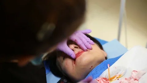 Cosmetician doing permanent make-up to her client in the salon Stock Footage 76190366