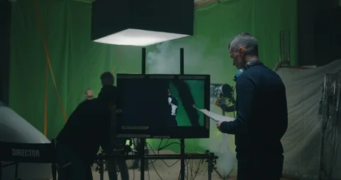 Cosmetician preparing an actor while others discussing the scene Stock Footage 124886383